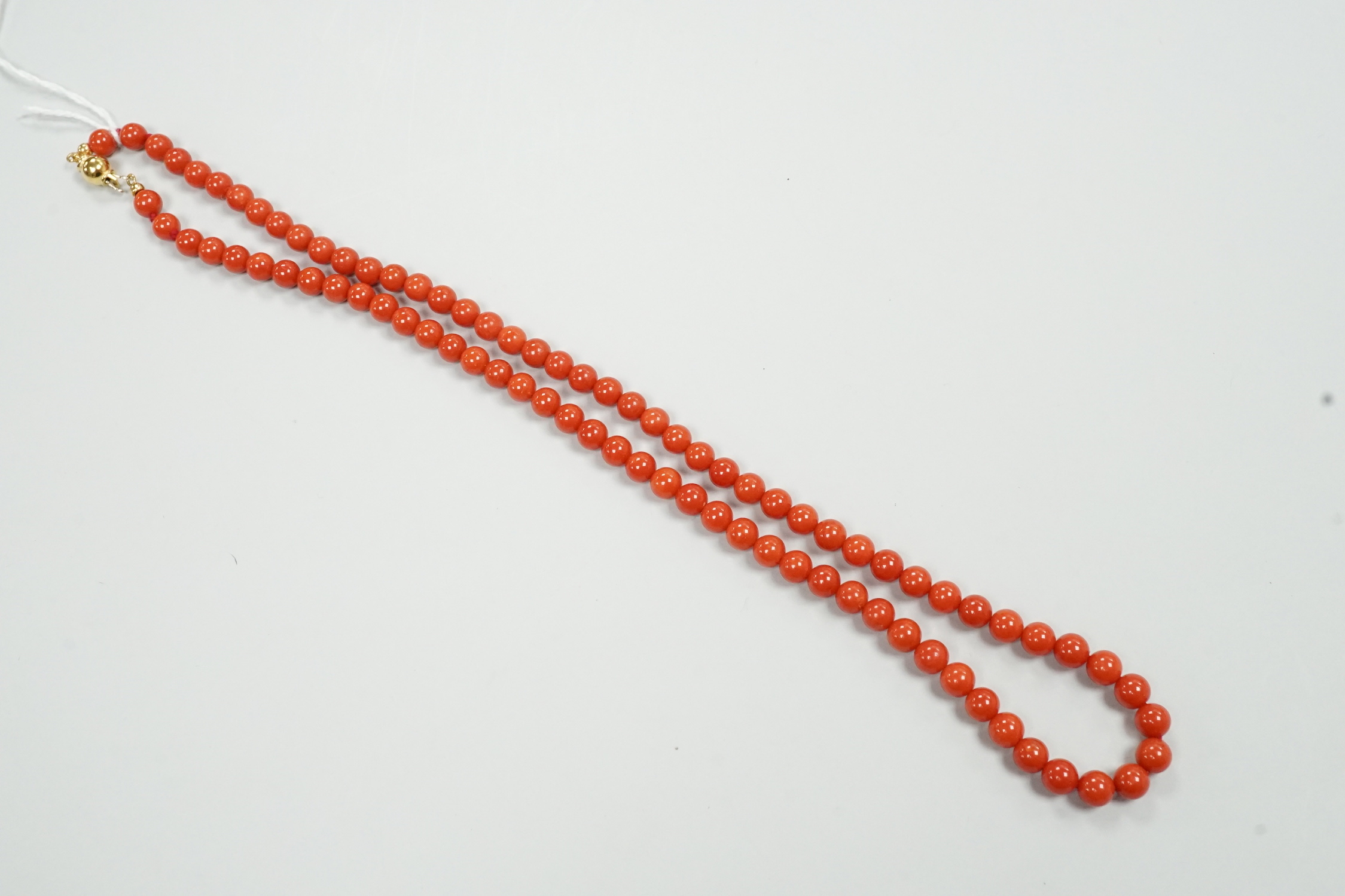 A single strand coral bead necklace, with 750 yellow metal clasp, 48cm.